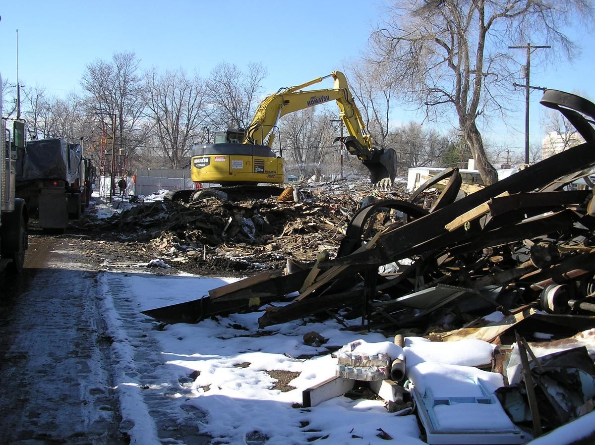 Multiple machines removing debris on a remediation site