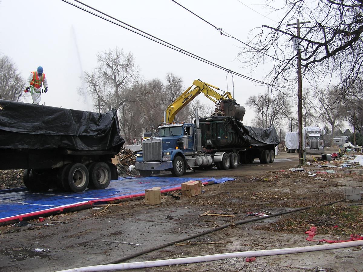 Loading a covered trailer past perimeter containment fencing