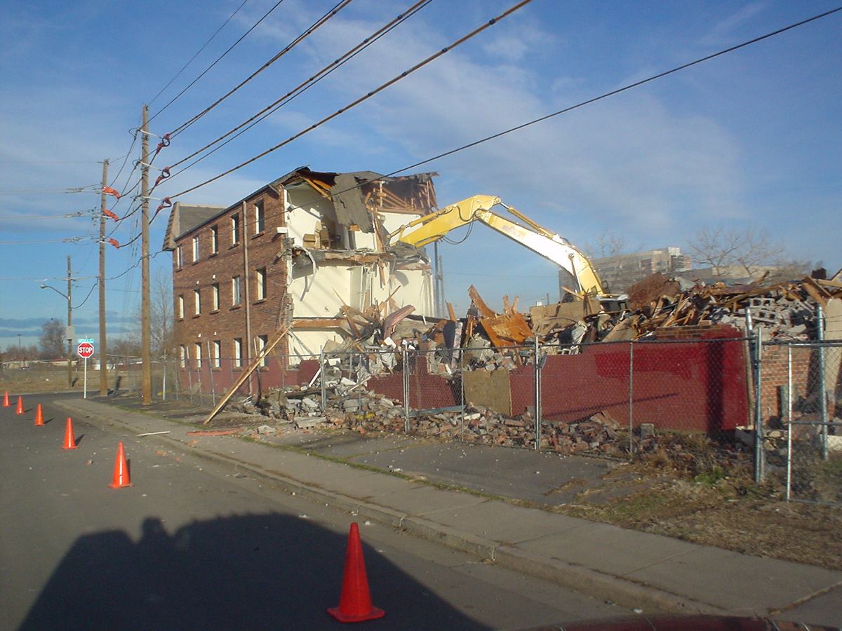 Commercial building demolition on a fenced, controlled site