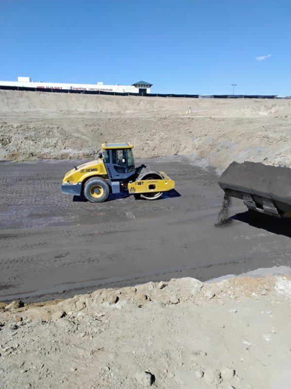Smooth-drum roller compacting subgrade in a large over-excavation