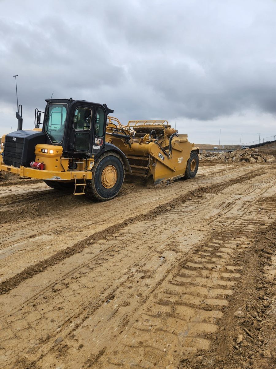 CAT 623K wheel scraper moving material on a haul road