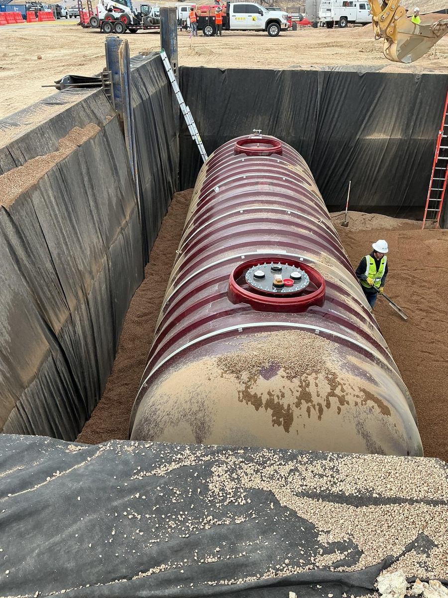 Fuel tank being backfilled with pea gravel in a shored trench