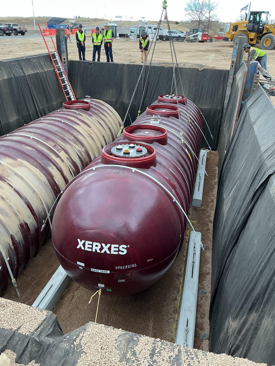 Multiple Xerxes fiberglass fuel tanks set in a shored excavation