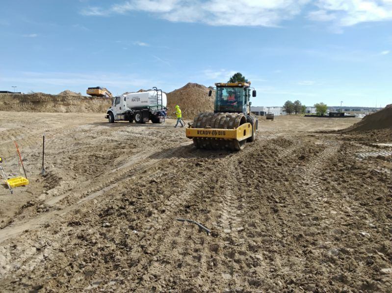 Dozer spreading and grading a building pad