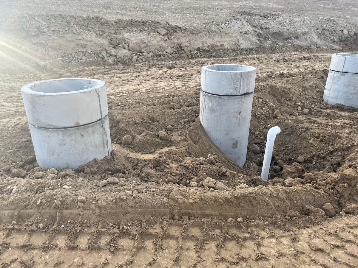 Precast access risers set on the interceptor pad with PVC piping