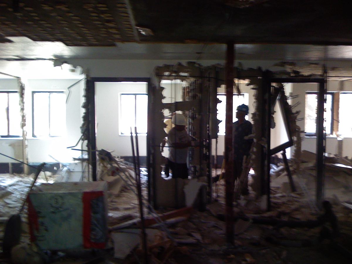 Crew gutting interior partitions down to the structure