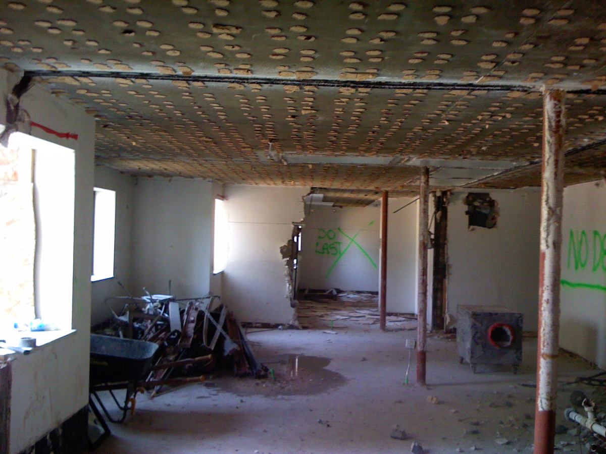 Interior floor stripped to the deck with debris cleared by hand