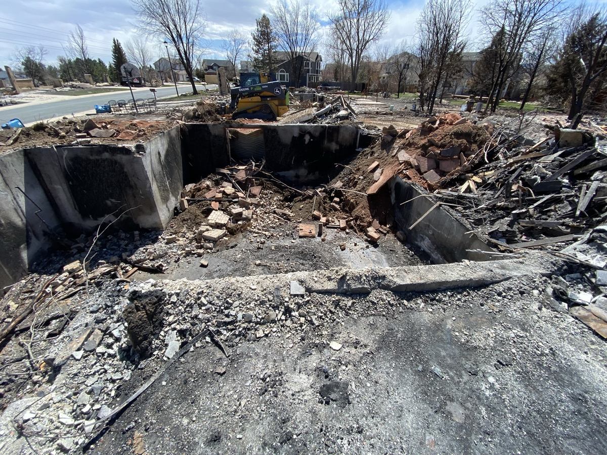 Burned foundation and structural debris