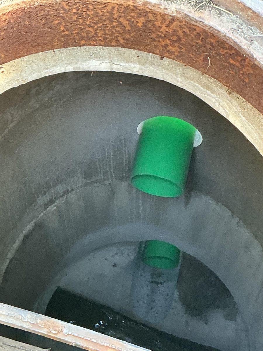 Sanitary sewer pipe stub entering a concrete manhole
