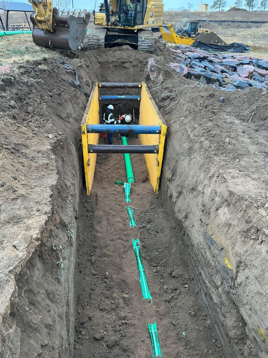 Sanitary sewer main run installed with a trench box for shoring