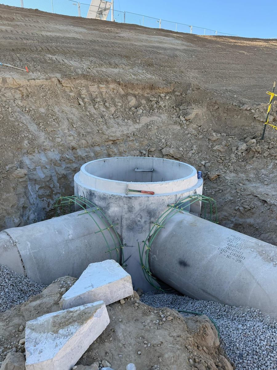 Cast-in-place concrete junction structure joining multiple RCP storm pipes
