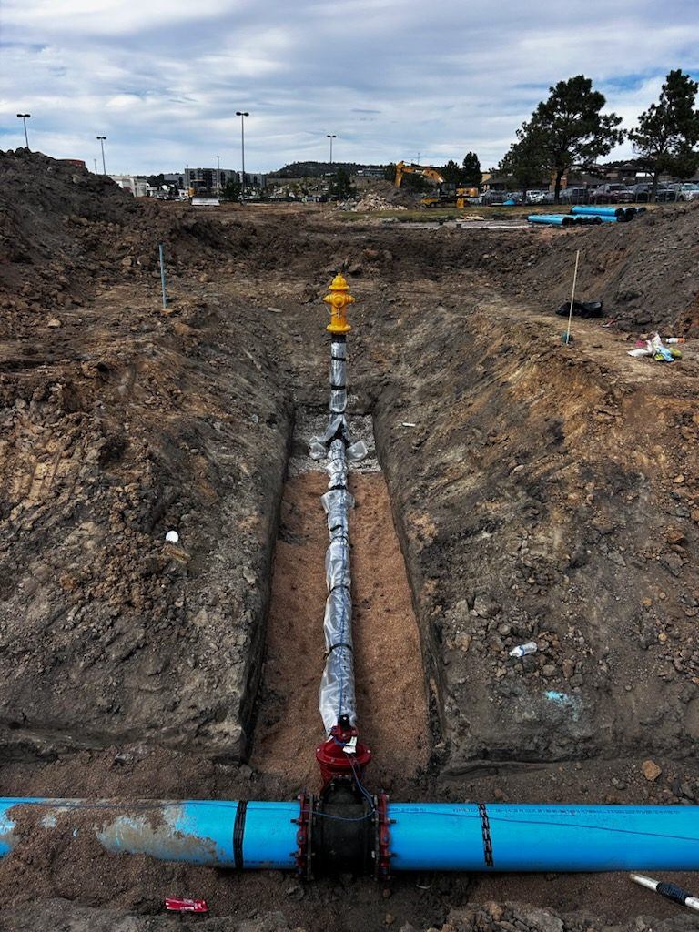 Fire hydrant set on a valve over a wrapped C-900 water main in the trench