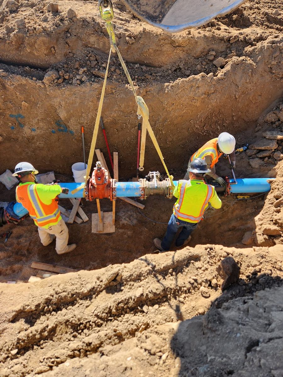 Crew setting valves and mechanical-joint fittings on a C-900 water main